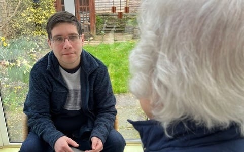 Andy Denison speaking to a resident in Tonedale about the impact of the power cuts.