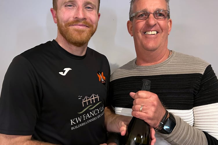 Wellington's Player of the Match Miles Quick (left) receives his award from the club's former striker Bob Cummins.