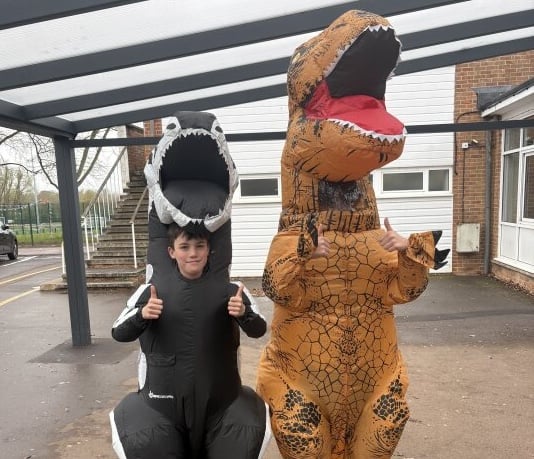 Two pupils dressed in dinosaur costumes for the run