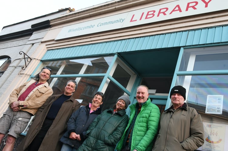 Wiveliscombe Town Hall trustees outside the town's community library, which they have saved by agreeing to manage it for the next seven years.
