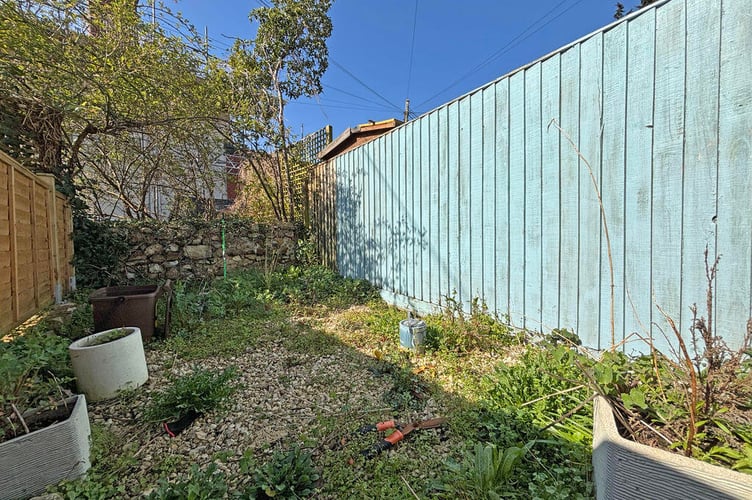 The garden is accessed via a passageway to the side of the property