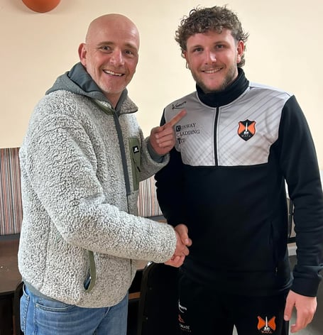 Player of the match Sam Poole (right) is pictured being congratulated by former manager and player Sean Buttle.  