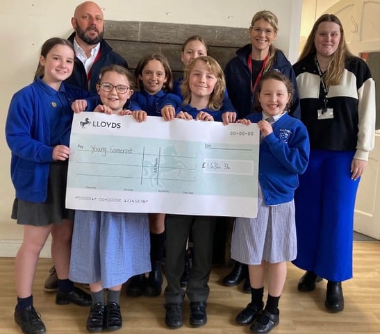 West Buckland School present a cheque to Young Somerset for more than £1,500 after successful Dance-A-Thon.