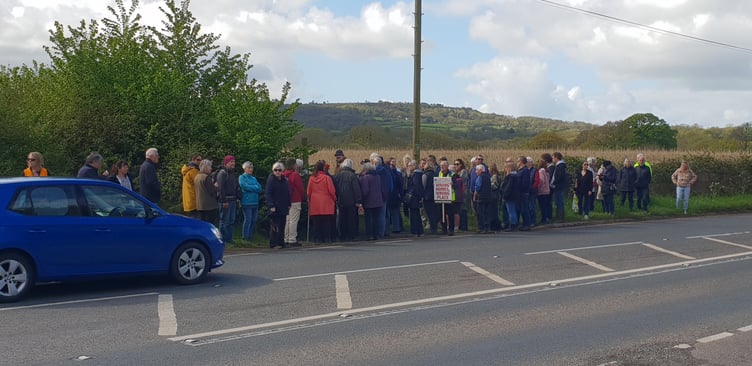 Some of the protesters gathering for a Protect Wellington mass demonstration against housing planned in the fields behind them.