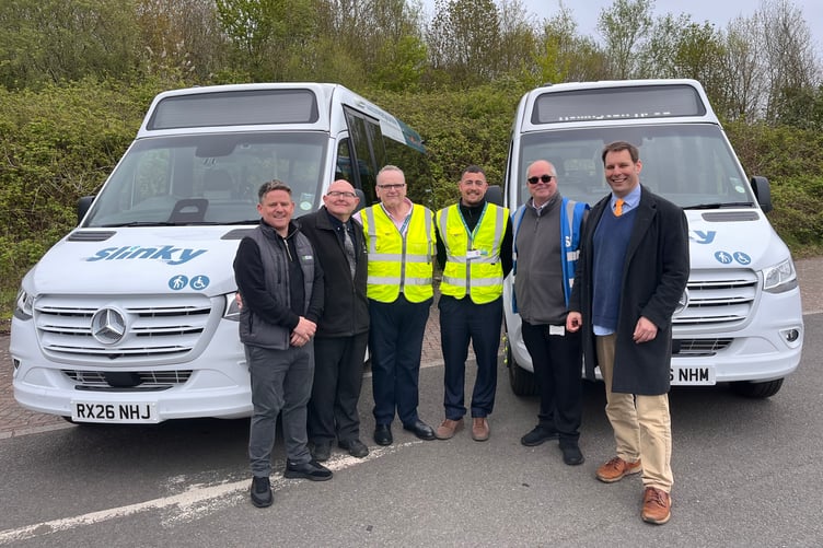 Two of the new Digital Slinky buses with (left to right) EVM supplier Steve Haywood, council transport operations manager Lee Jones, driver Mark Lee, council transport co-ordinator Justin Poat, council area operations manager Vince Carey, and Cllr Richard Wilkins.