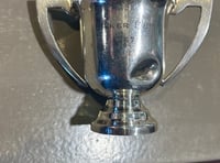 How did a replica of Baker Cup find its way into a garden? 