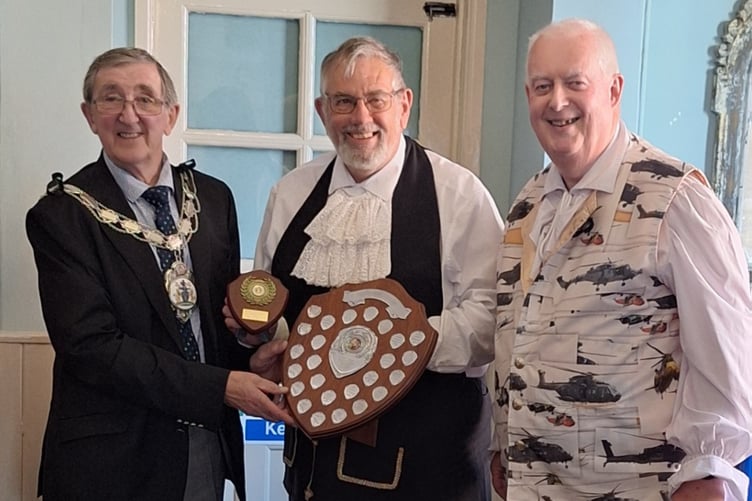 A jubilant Wellington town crier with his perpetual shield that will be on display at town council reception at 30 Fore Street.