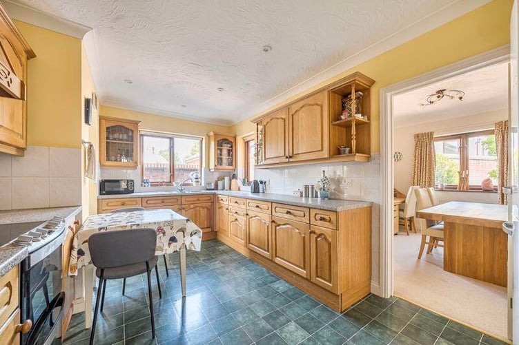 The kitchen is fitted with a comprehensive range of wall and base units