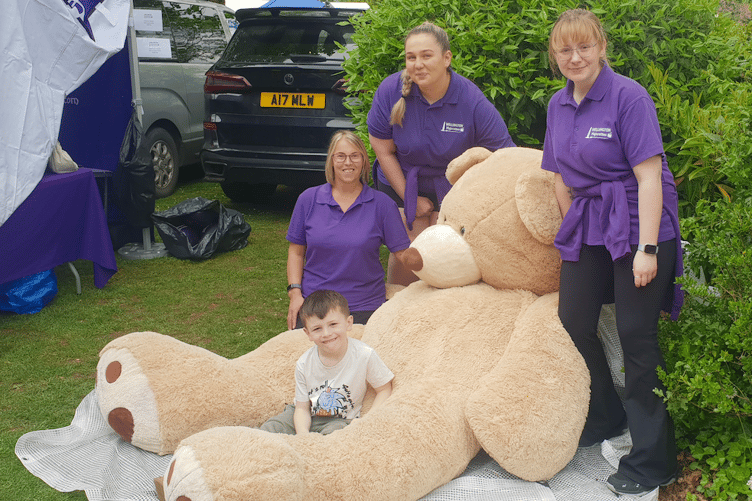 Wellesley Park Primary School pupil Finley Bates was thrilled when he was gifted this giant teddy bear after it was won by Ryleigh Priddle in a tombola on the Wellington Majorettes stall at the annual spring fair.