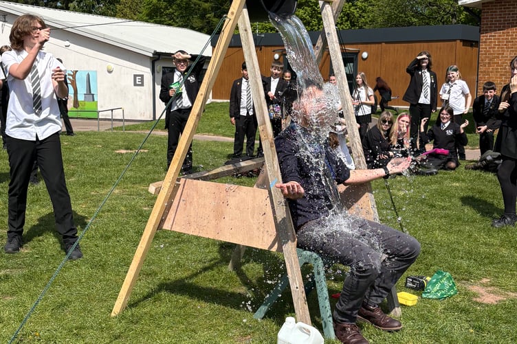 A teacher gets a drenching for a great cause in the school's annual Madagascar Week.