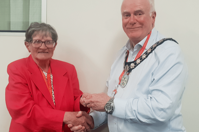 New Wellington mayor Cllr Mark Lithgow presents outgoing mayor Cllr Janet Lloyd with her past mayor's pin