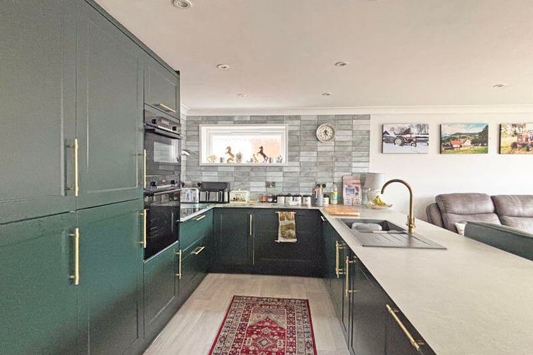 The kitchen is fitted with a comprehensive range of wall and base units