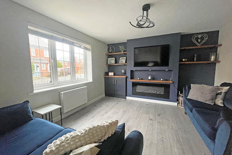 The sitting room is a generous size with a window to the front elevation and a feature fireplace