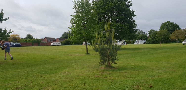 'Traveller' caravans and vehicles can be seen spread around the perimeter of a council-owned field off Hoyles Road, Wellington.
