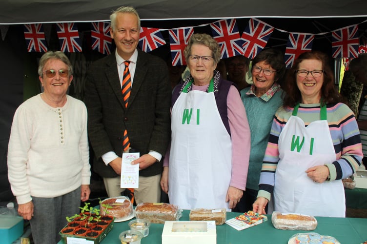 MP Gideon Amos attended the Spring Fayre in the beautiful Wellington park. He said it was "super well-attended" and he was pleased to be able to meet up again with Reminiscence Learning and their great volunteers. He is pictured here on the Women's Institute stand with a number of volunteers