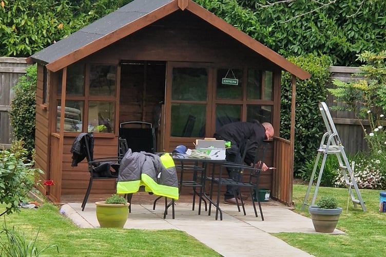 A shed at The Old Vicarage being spruced up by local corporate volunteers helping to transform the garden.