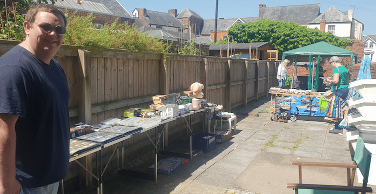 Alex Conway with visitors to his yard sale in Clifford Mews as part of Wellington's first jumble trail on Sunday.