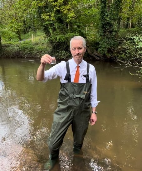 Wellington MP Gideon Amos takes water samples in the Tone.