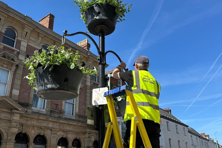 Blue skies as the baskets full of petunias in purple, red and white take pride of place.
