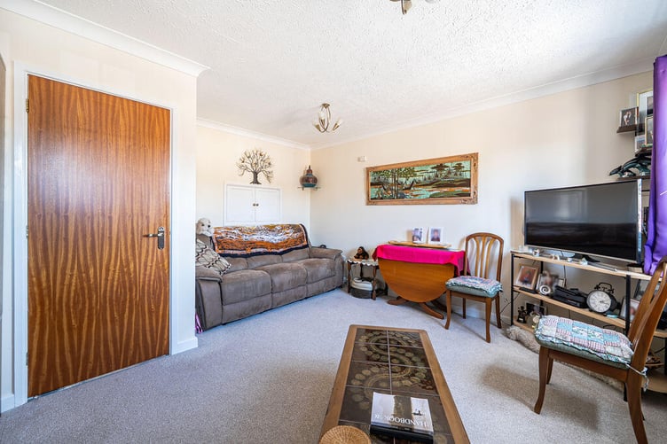 The sitting/dining room is open plan in concept