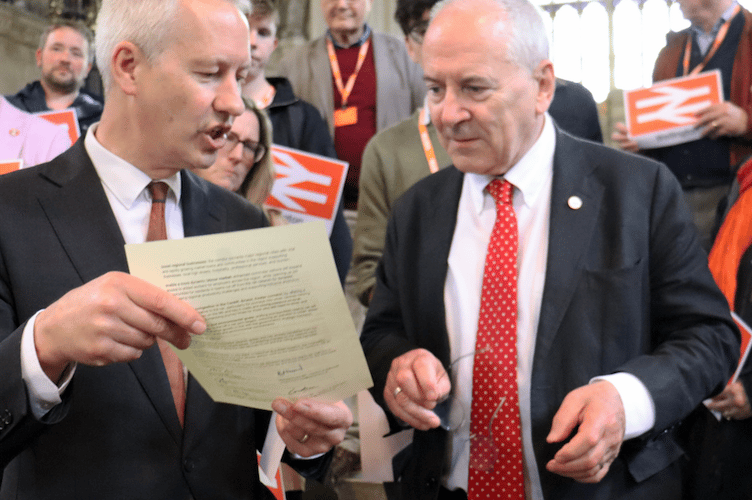Wellington MP Gideon Amos (left) delivers a letter to Rail Minister Lord Hendy calling for support for the town's planned railway station.