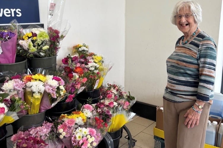 Care home resident Jean enjoying the flowers on the recent trip to the local supermarket.