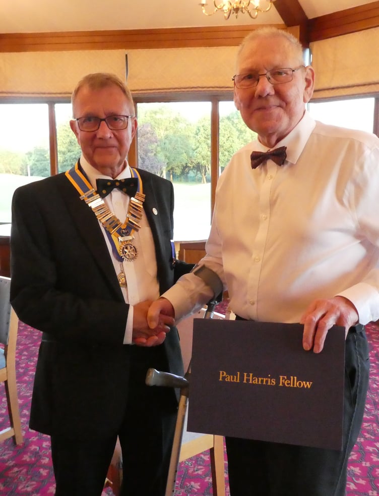 Rotarian Mike Field receives his Paul Harris Fellowship from president Brian Withers.