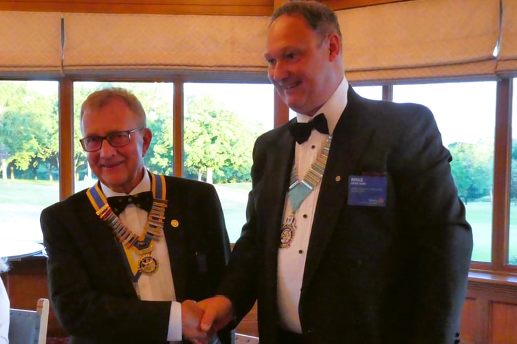 New president of the Rotary Club of Wellington, Brian Withers, receives his chain of office from Rotary district governor Mike Kew.