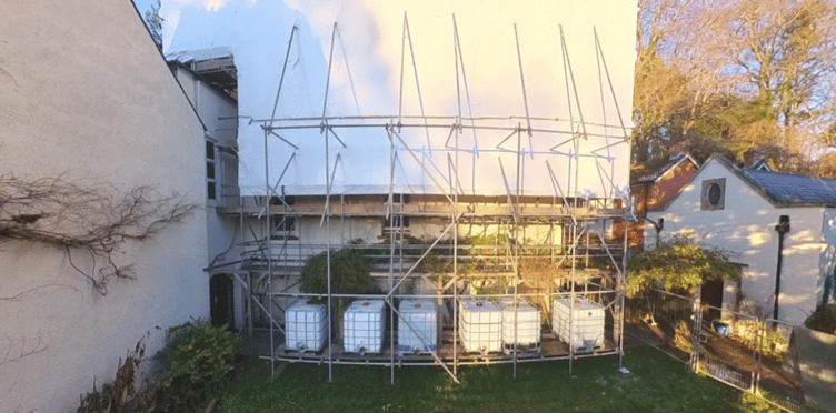 Protective scaffolding covers the east wing of Bindon House, Langford Budville, following a devastating fire last year.