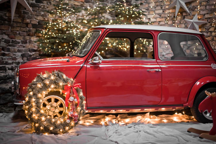 Red mini car bedecked in Christmas lights