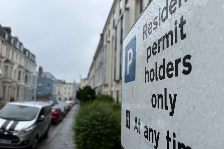 A parking sign in a resident permit zone