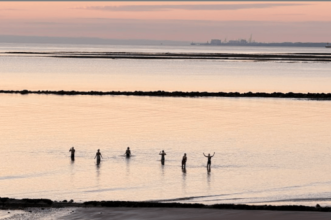 Swimmers take a summer solstice sunrise dip in the sea at Minehead ahead of a Met Office amber heatwave warning.