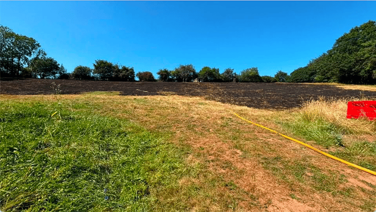 Two-and-a-half acres of countryside near Wellington burned when a bonfire became out of control during the heatwave.