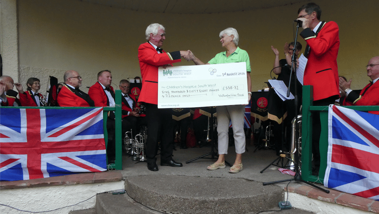 Wellington Silver Band chairman Geoff Samuel presents a cheque to Children's Hospice South West's Eileen Mitchell during the band's Proms in the Park evening.