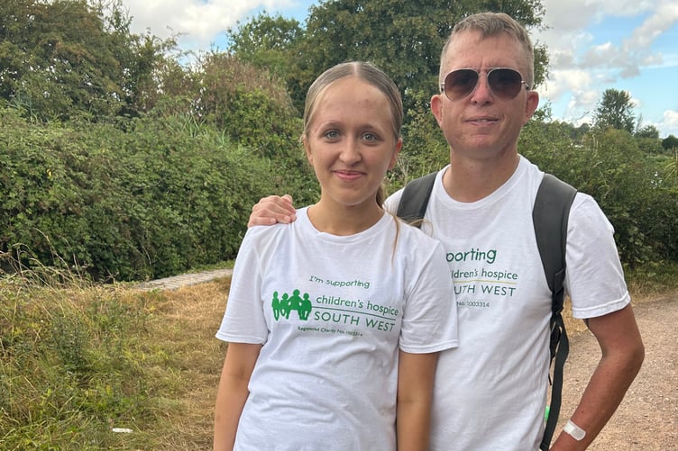 Freya, with her father Mike, taking a breather and collecting donations at the halfway point.