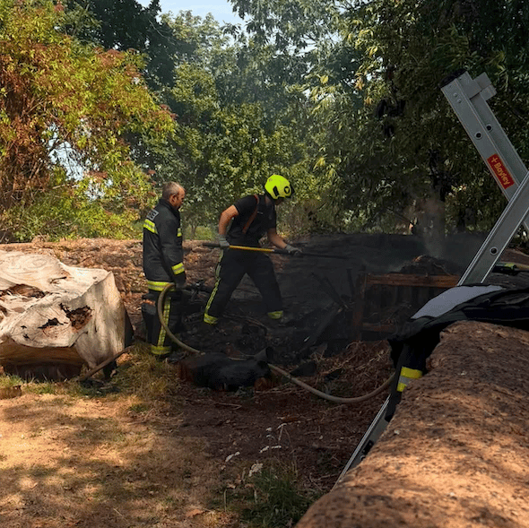 Firefighters tackle a compost heap fire in Oake Parish Church churchyard on Sunday.