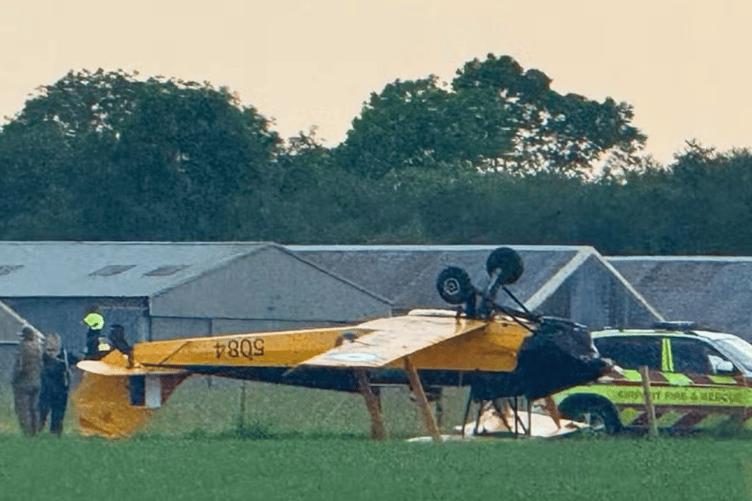 Rob Doughton's Tiger Moth upside down after a landing went wrong at Dunkeswell Airfield in May.