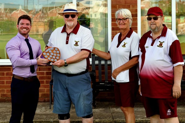 Scott Kingdom, of Oaktree Court, presents the winning shield to, left to right, Bill Warnett, Debbie Lane and Tony Stone.