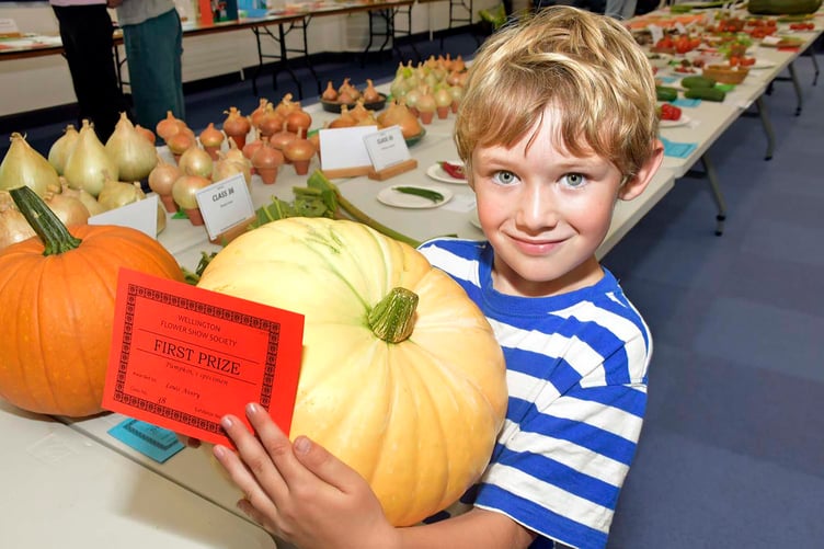 First place for Louis Avery looking pleased as punch with his prize-winning pumpkin.