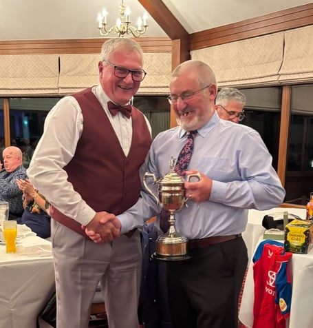 Tony Hutchings (left) receives the Clubman of the Year trophy from Wellington Cricket Club's president Bernie Burnett