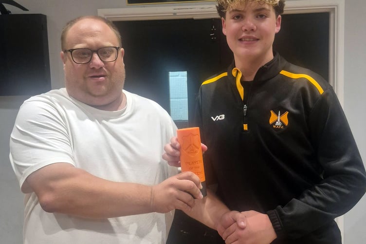 Man of the Match Ollie H is presented with his award by kit man Adrian Ridgeway