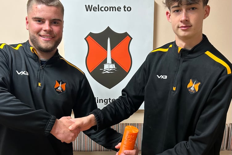 Player of the match Freddie (right) is presented with the trophy by Elijah.