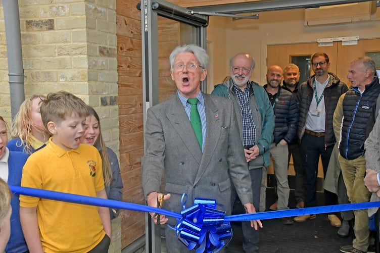 Former governor John Hannon, one of a group who saved Stawley Primary School from closure nearly 45 years ago, cut a ribbon to open the new school building to a rousing chorus of 'We love Stawley School'. PHOTO: Alain Lockyer.