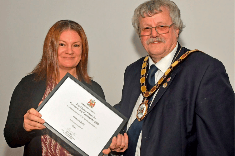 Frances Gully, of Oake, receives her community champion award from Somerset Council chairman Cllr Mike Best.
