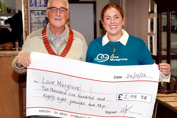 President Mike Groves hands over a cheque to Rachael Szaruta from Love Musgrove